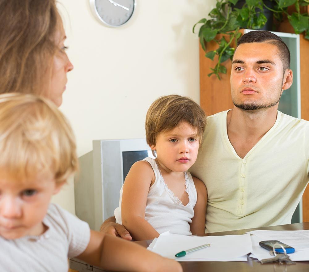 upset parents discussing issues with children present