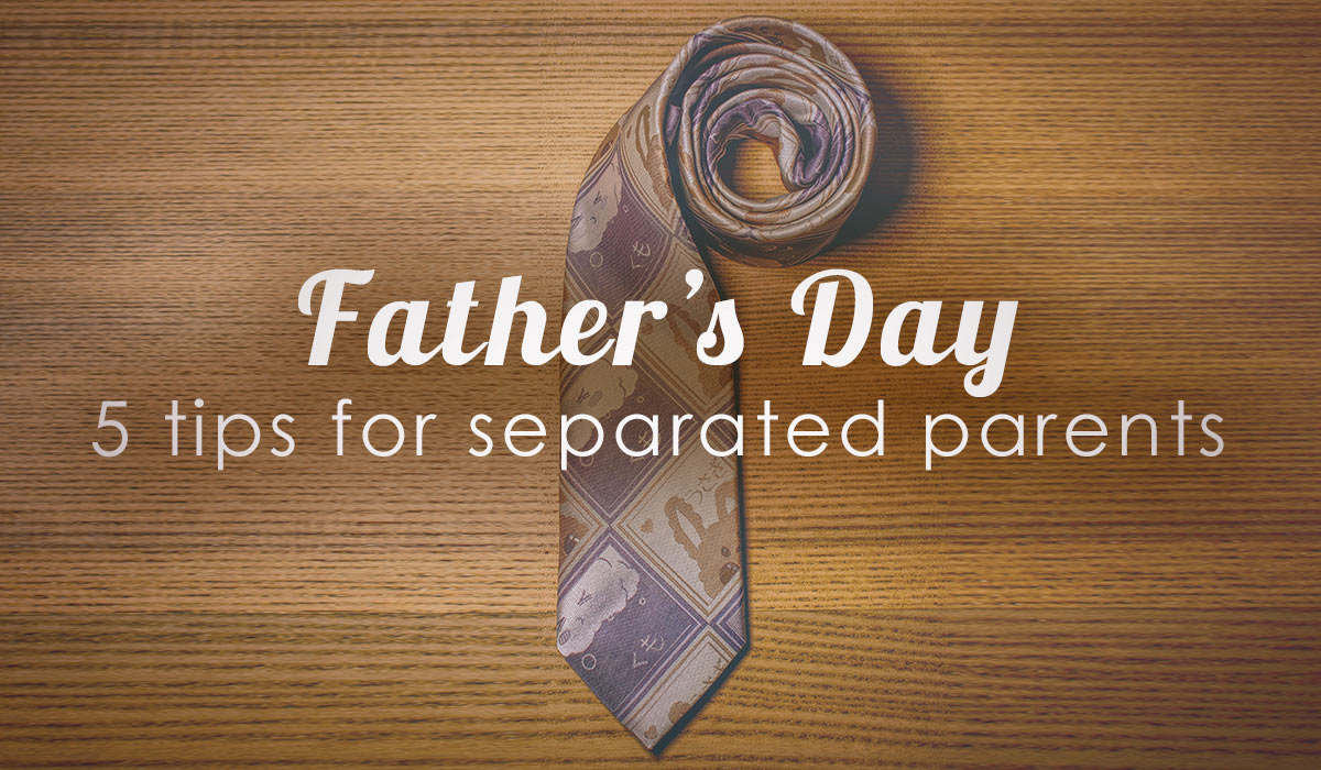 curled up tie on a wooden desk with words fathers day five tips for separated parents