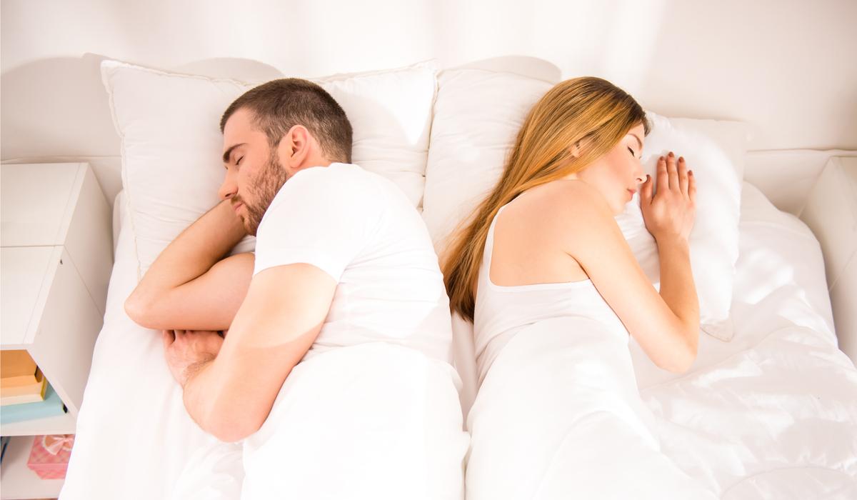young couple with sex problem sleeping in bed