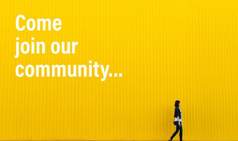 Words come join our community with woman walking past a hoarding