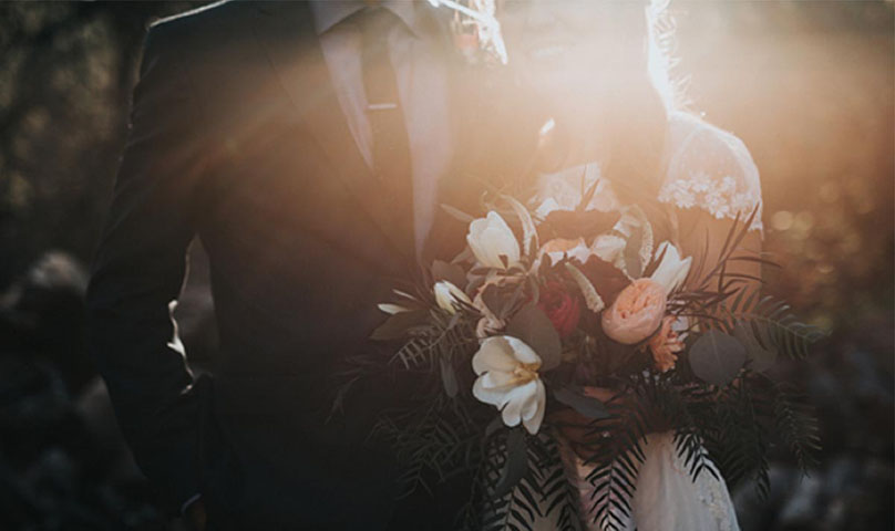 wedding couple bathed in a ray of sunlight