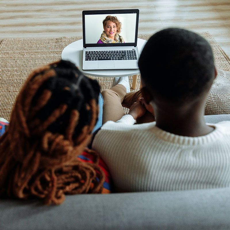 African Caribbean couple in online therapy session