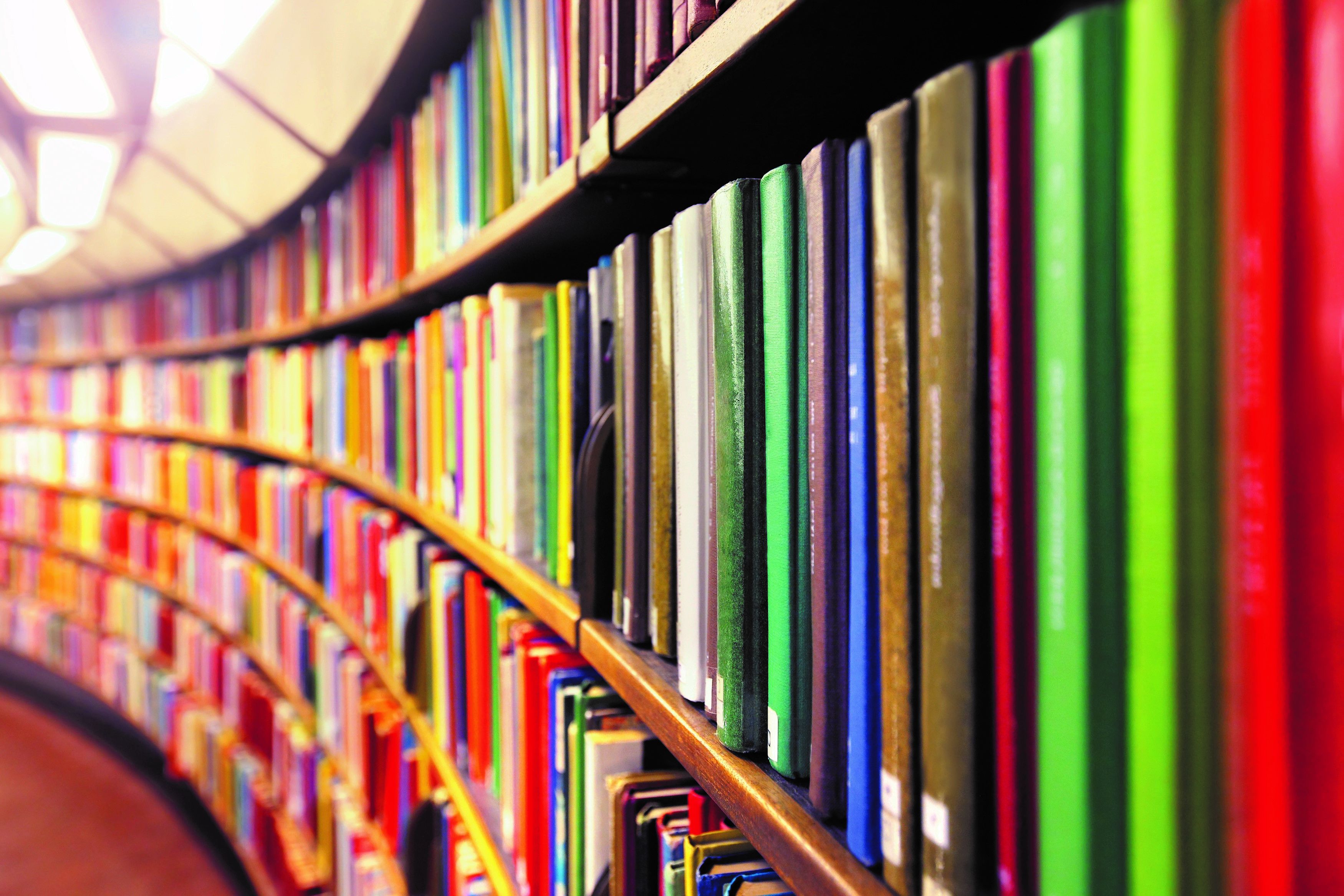 library shelves with rows of colourful publications