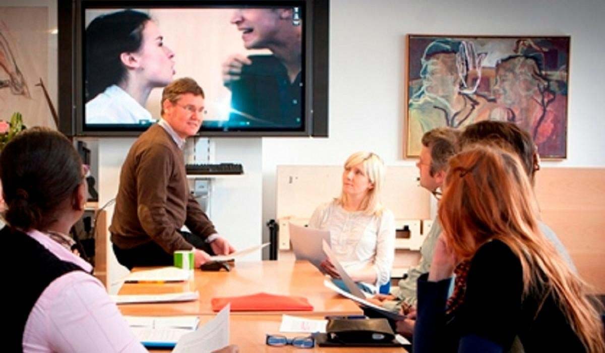 group of adults in a training session looking at a conflict scenario video