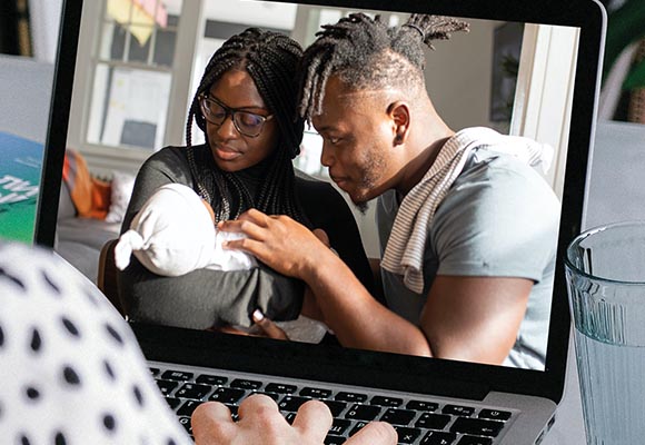 african carribbean couple with baby on laptop meeting with therapist