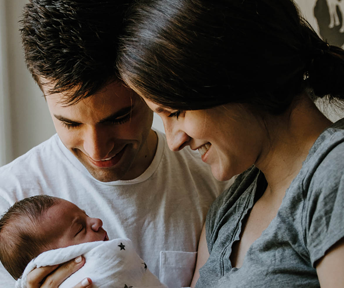 parents holding small baby