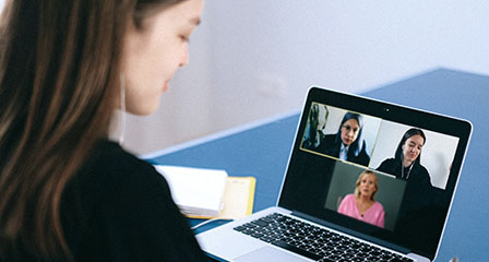 woman doing an online course viewing other participants on her laptop