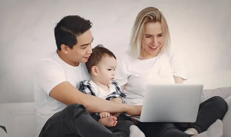parents with baby in laptop meeting
