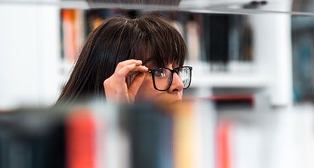 woman in library looking at books